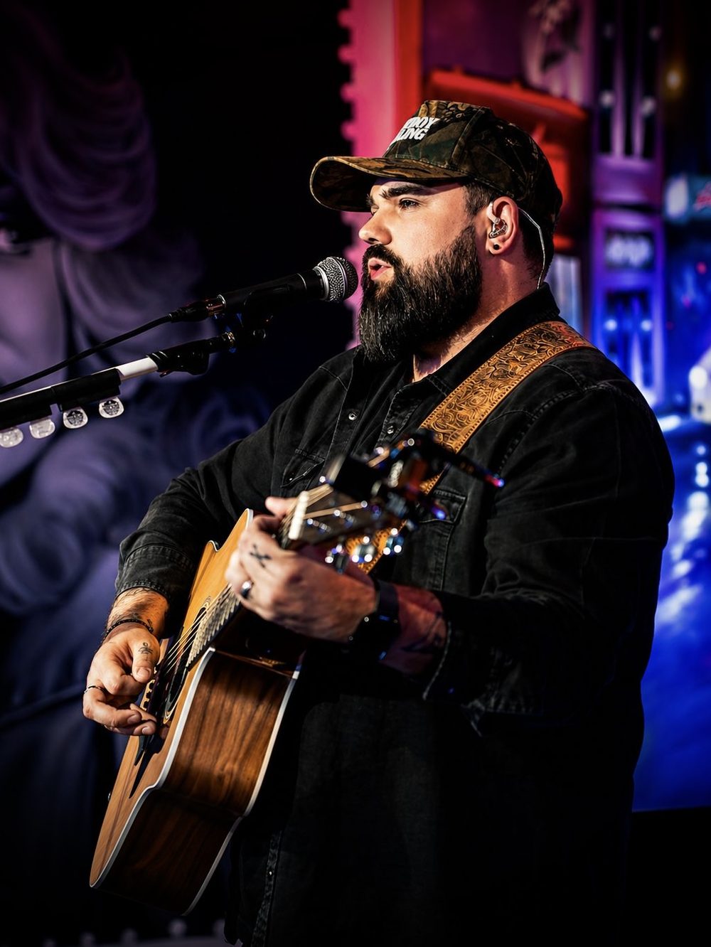 Kerryl with guitar under red lights