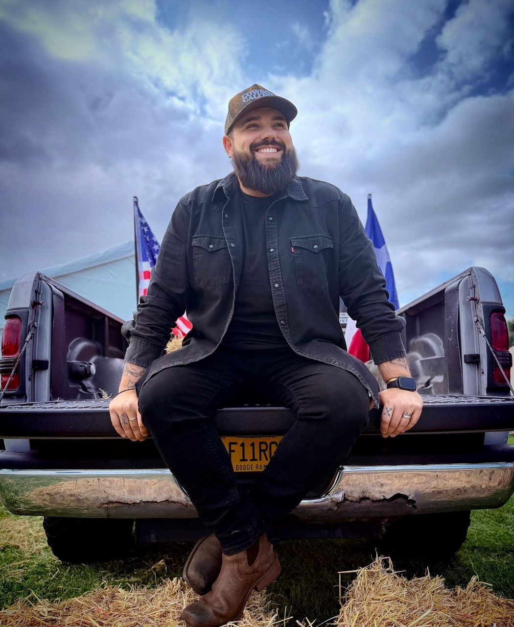 Kerryl sitting on the tailgate of a pickup truck